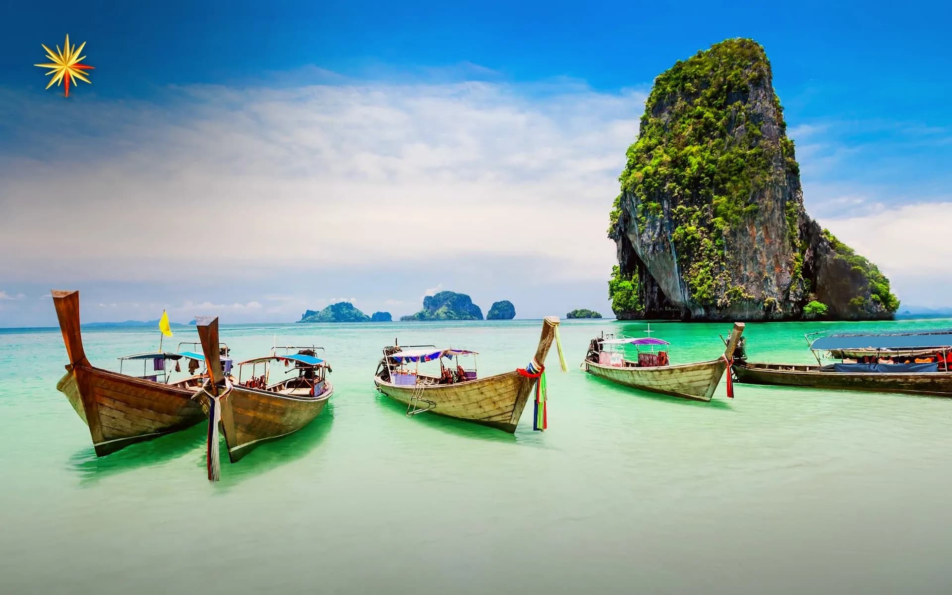 Longtail boats on a turquoise Andaman beach